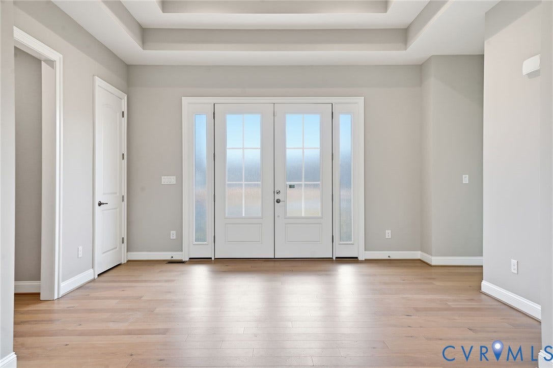 18132 Dogwood Trail Way, Rockville, VA 23146 Double entry doors with glass pane inserts and flanking sidelights, complemented by wood-finish flooring and a tray ceiling