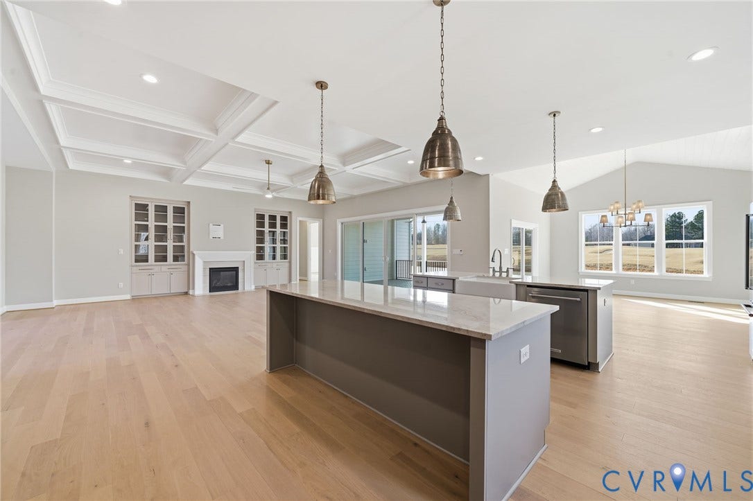 18132 Dogwood Trail Way, Rockville, VA 23146 Coffered ceiling, wood-finish flooring, kitchen island with stone countertop, built-in cabinetry with fireplace, and pendant lighting