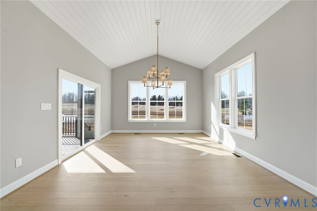 18132 Dogwood Trail Way, Rockville, VA 23146 Vaulted tongue-and-groove ceiling, wood-finish flooring, multi-light chandelier, double-hung windows, and sliding glass door