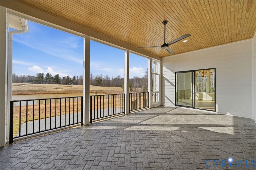 18132 Dogwood Trail Way, Rockville, VA 23146 Covered porch featuring a herringbone-patterned paver floor, wood-paneled ceiling, black metal railing, and a ceiling fan