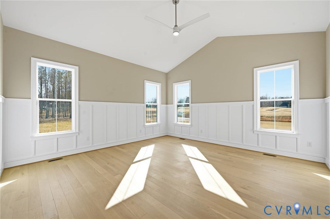 18132 Dogwood Trail Way, Rockville, VA 23146 Vaulted ceilings, wood-finish flooring, white board-and-batten wainscoting, and a modern ceiling fan