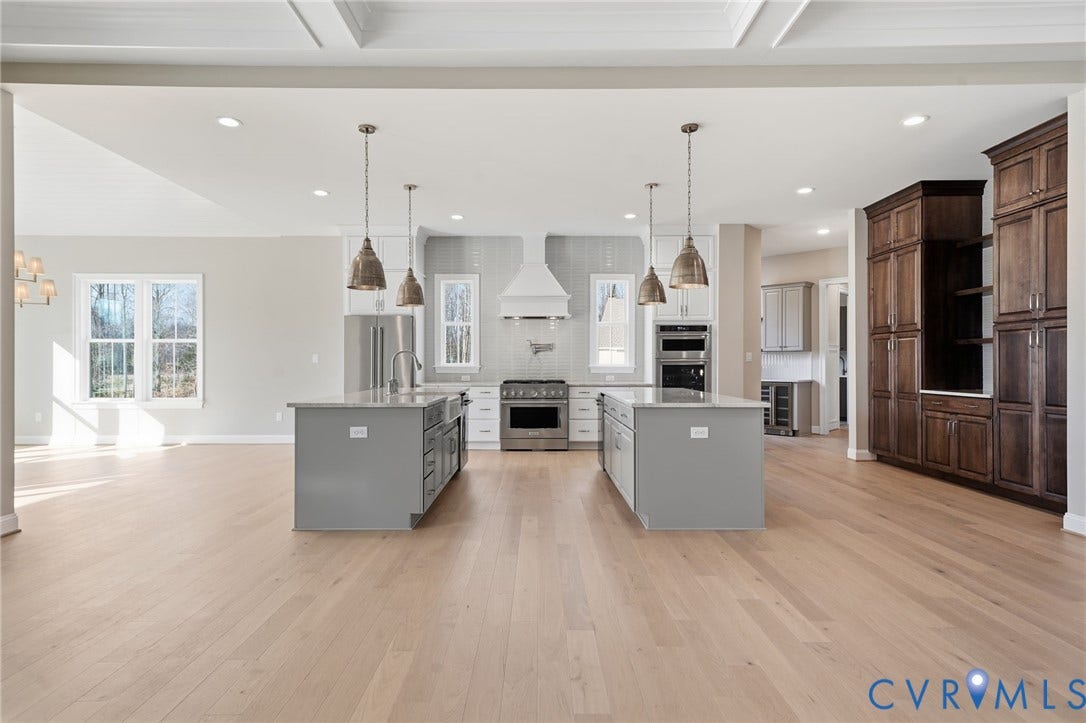 18132 Dogwood Trail Way, Rockville, VA 23146 Kitchen featuring dual islands with stone countertops, stainless steel appliances, coffered ceiling, and custom wood-finish cabinetry