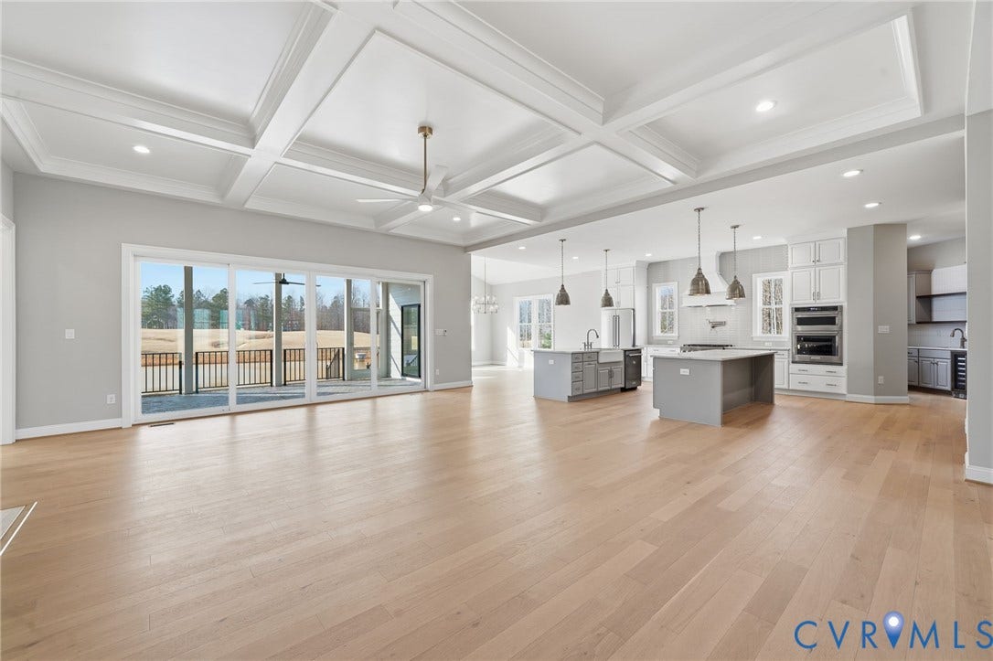 18132 Dogwood Trail Way, Rockville, VA 23146 Coffered ceilings with recessed lighting, wood-finish flooring, sliding glass doors, and a kitchen featuring dual islands and built-in stainless steel double ovens