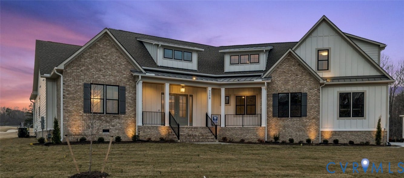 18132 Dogwood Trail Way, Rockville, VA 23146 Multi-gabled exterior featuring stone masonry, vertical board-and-batten siding, a covered front porch, and black metal railings