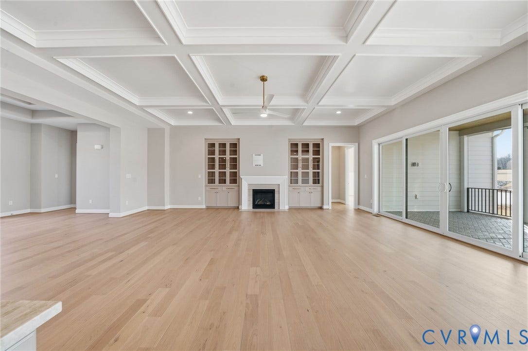 18132 Dogwood Trail Way, Rockville, VA 23146 Coffered ceiling, wood-finish flooring, built-in cabinetry, fireplace with a mantle, and multi-panel sliding glass doors