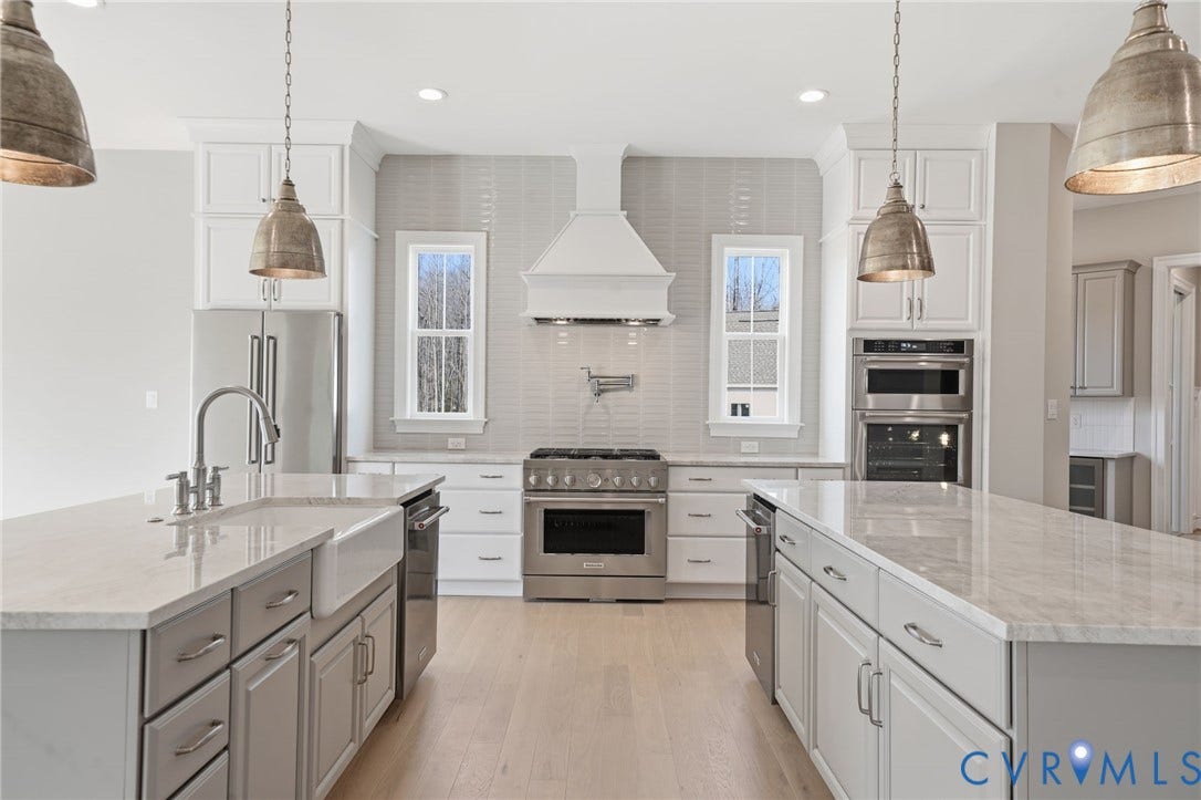 18132 Dogwood Trail Way, Rockville, VA 23146 Kitchen featuring dual islands with stone-composite countertops, shaker-style cabinetry, stainless steel professional-grade appliances including a wall-mounted pot filler, and wood-finish flooring