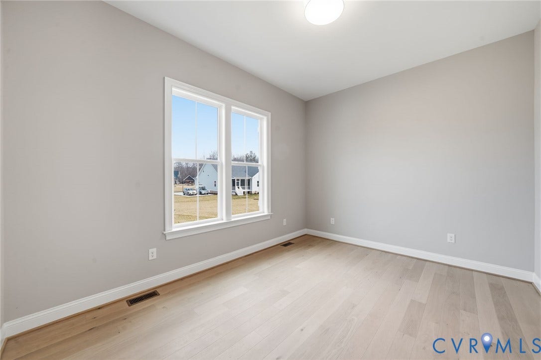 18132 Dogwood Trail Way, Rockville, VA 23146 Room featuring neutral-toned walls, wood-finish flooring, and a dual-pane window
