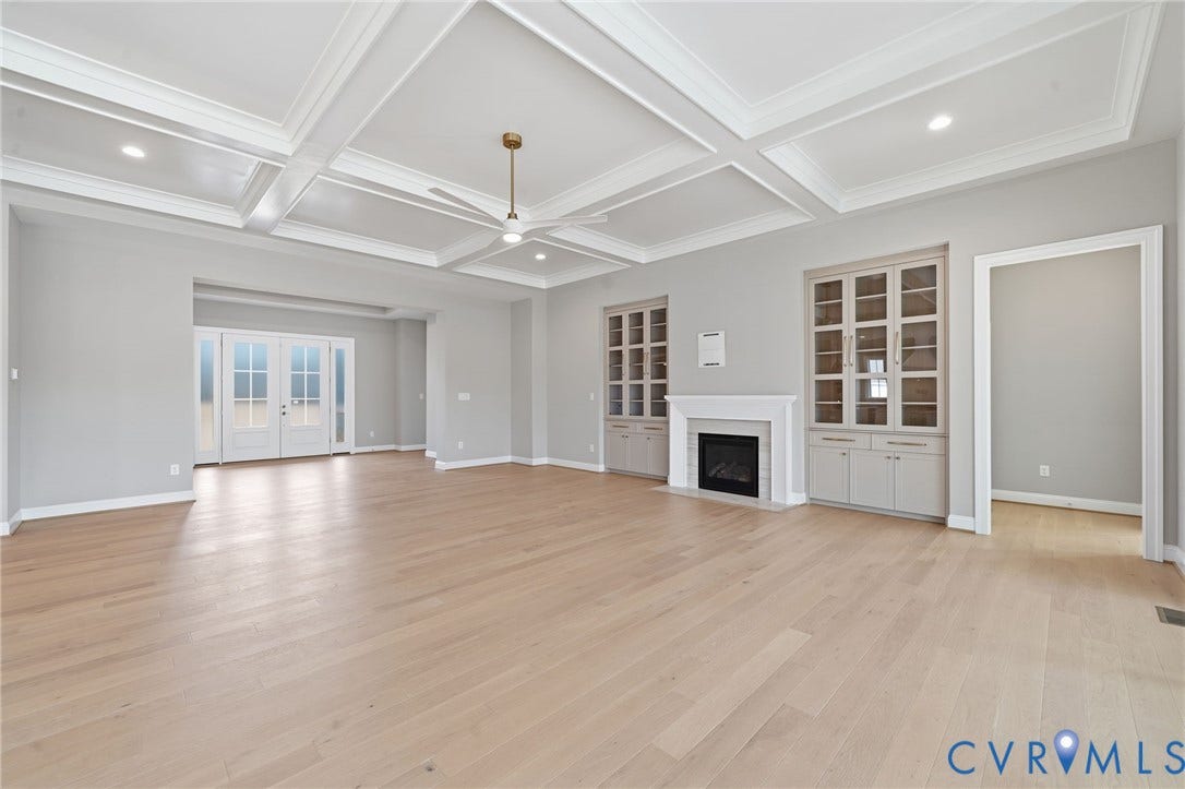 18132 Dogwood Trail Way, Rockville, VA 23146 Coffered ceiling, wood-finish flooring, built-in glass-front cabinetry, gas fireplace with decorative mantel, and double-door exterior entry