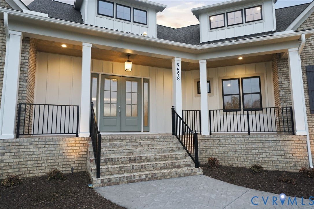 18132 Dogwood Trail Way, Rockville, VA 23146 Covered entryway featuring a brick facade, board-and-batten siding, double front doors with glass paneling, and black metal railings
