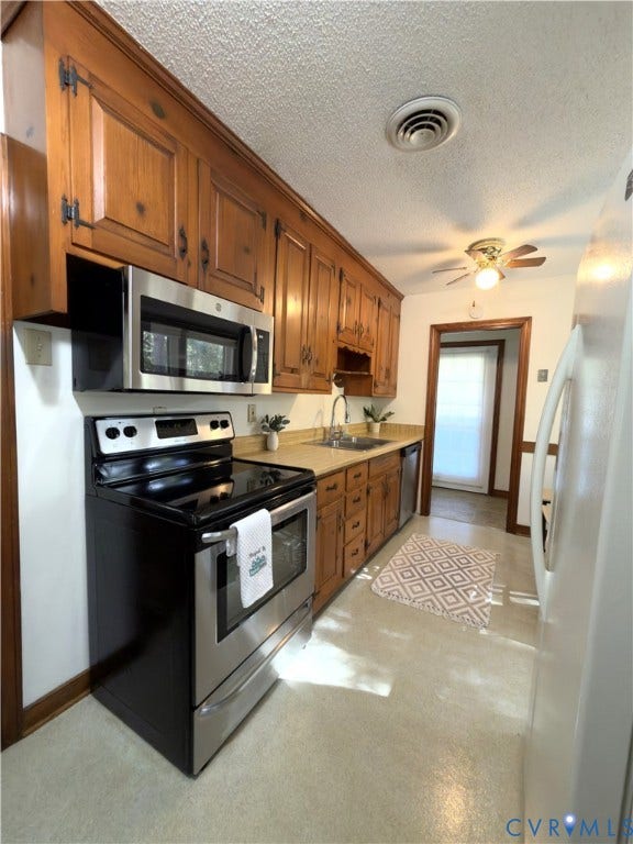 9012 Shawonodasee Road, Courthouse, Chesterfield, VA 23832 Kitchen featuring custom wood cabinetry, stainless steel appliances, and integrated countertop surfaces