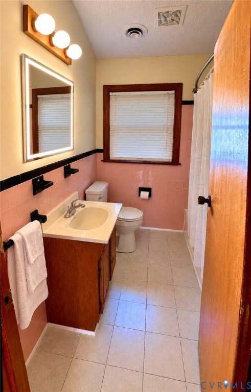 9012 Shawonodasee Road, Courthouse, Chesterfield, VA 23832 Bathroom featuring ceramic tile flooring, a wood-finish vanity with a drop-in sink, an illuminated vanity mirror, and black wall-mounted hardware