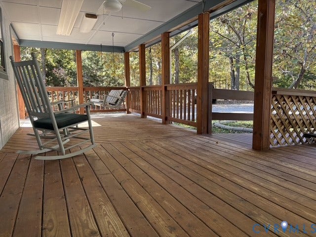 9012 Shawonodasee Road, Courthouse, Chesterfield, VA 23832 Covered wooden deck featuring horizontal railings, lattice skirting, a mounted ceiling fan, and overhead lighting