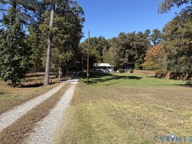 9012 Shawonodasee Road, Courthouse, Chesterfield, VA 23832 Expansive lot featuring a gravel drive, manicured lawn, perimeter wood fencing, and mature trees