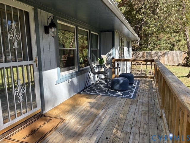 9012 Shawonodasee Road, Courthouse, Chesterfield, VA 23832 Covered exterior deck featuring wood decking, wood railing, vertical siding, and a decorative metal storm door