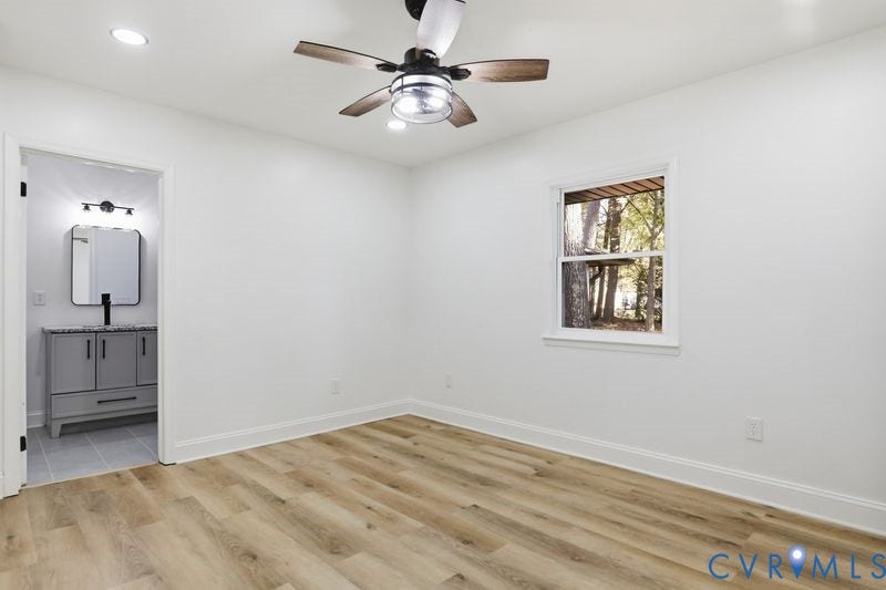 Interior space featuring wood-finish flooring, a ceiling fan with integrated lighting, recessed lighting, and a single-hung window
