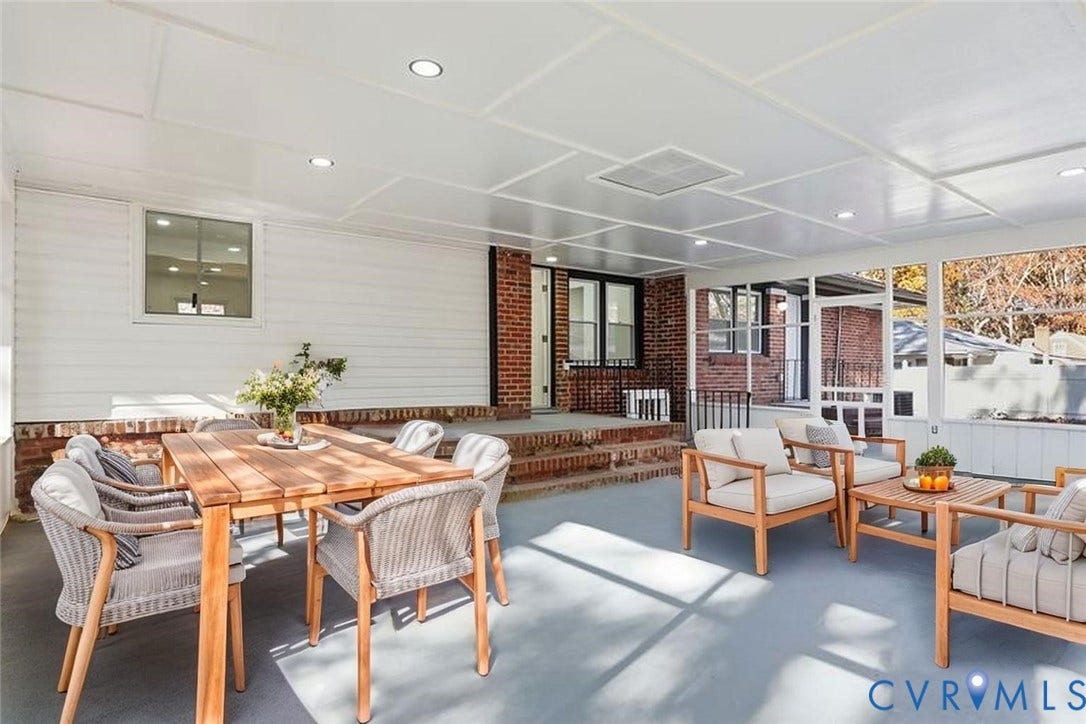Screened-in porch featuring a paneled ceiling with recessed lighting, red brick masonry, elevated brick steps, and light-tone siding
