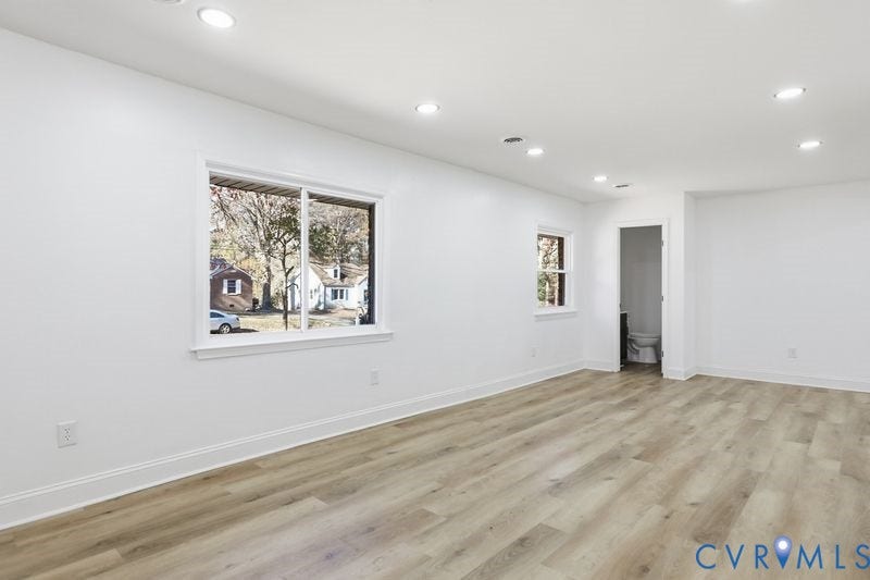 Interior space featuring wood-finish flooring, recessed lighting, and expansive windows