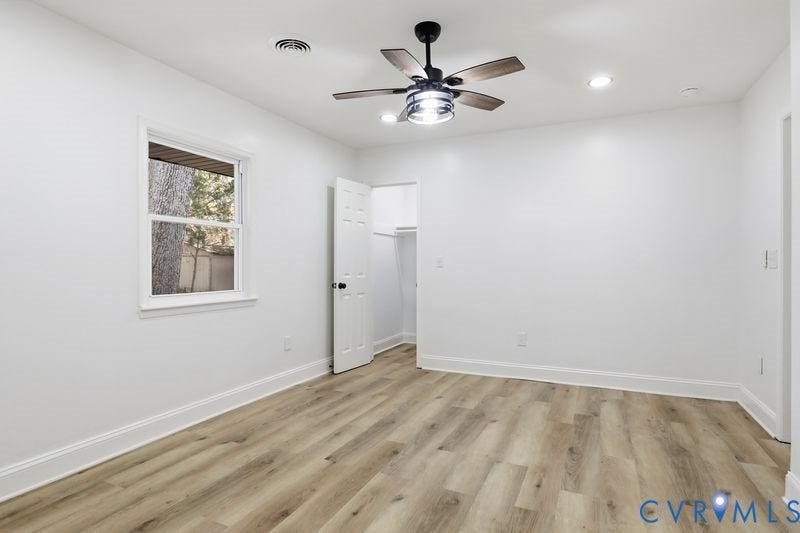Wood-finish flooring, recessed lighting, and a ceiling fan with integrated light fixture