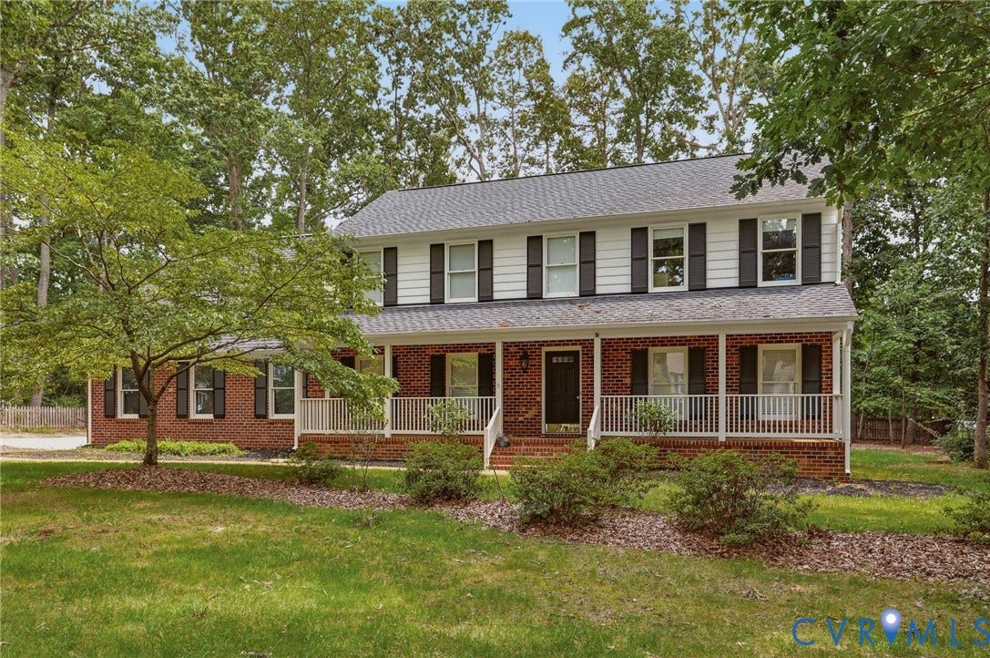 2311 Castle Hill Road, Midlothian, VA 23113 Two-story colonial exterior featuring red brick lower siding, white horizontal upper siding, dark shutters, and a full-length covered front porch with white railing