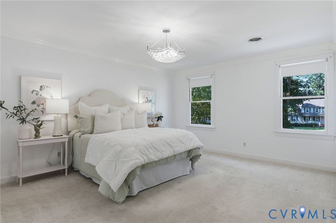 2311 Castle Hill Road, Midlothian, VA 23113 Room featuring neutral wall-to-wall carpeting, crown molding, double-hung windows, and a decorative crystal-style chandelier