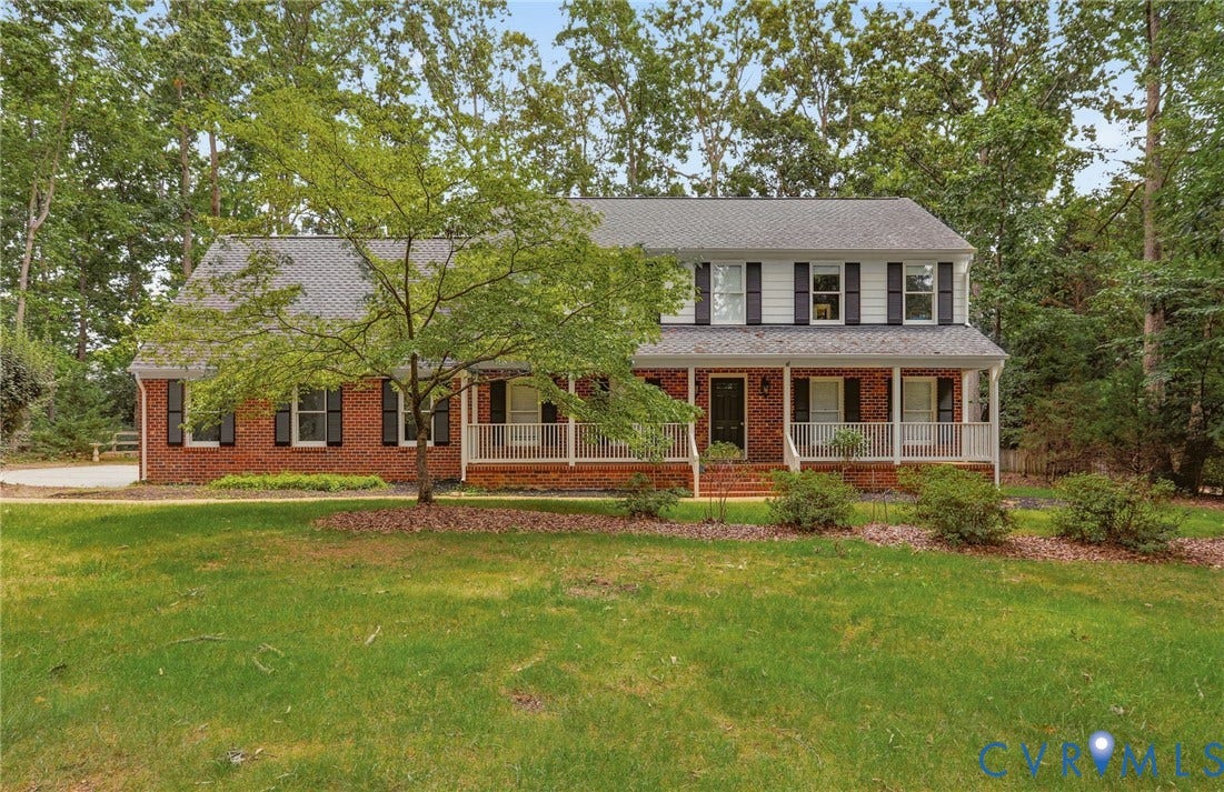 2311 Castle Hill Road, Midlothian, VA 23113 Traditional two-story exterior featuring a brick facade, white siding, a covered front porch with a wood-finish floor, shuttered windows, and a shingled roof
