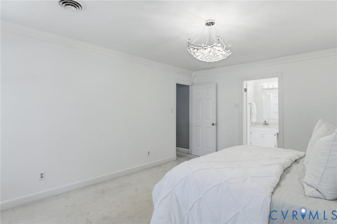 2311 Castle Hill Road, Midlothian, VA 23113 Room featuring crown molding, neutral carpeting, and a multi-tiered crystal chandelier
