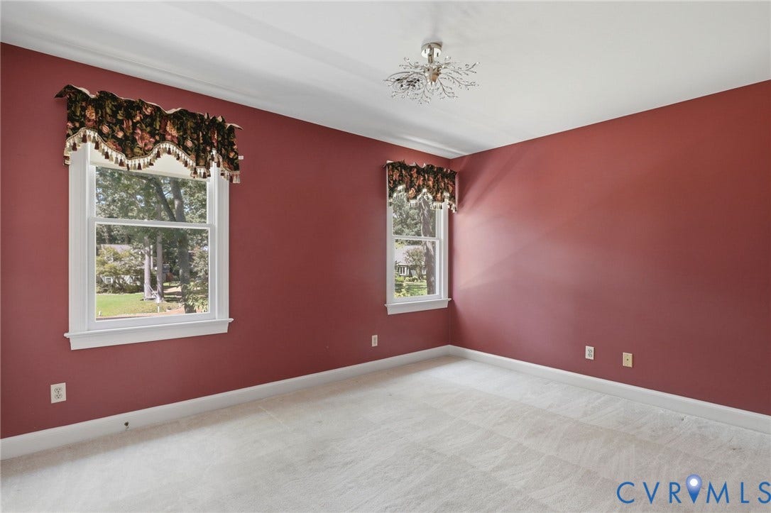 2311 Castle Hill Road, Midlothian, VA 23113 Interior space featuring neutral carpeting, double-hung windows, and a decorative multi-arm ceiling fixture
