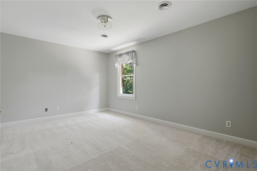 2311 Castle Hill Road, Midlothian, VA 23113 Neutral-toned interior space featuring wall-to-wall carpeting, a single-pane window, and a decorative flush-mount ceiling light fixture