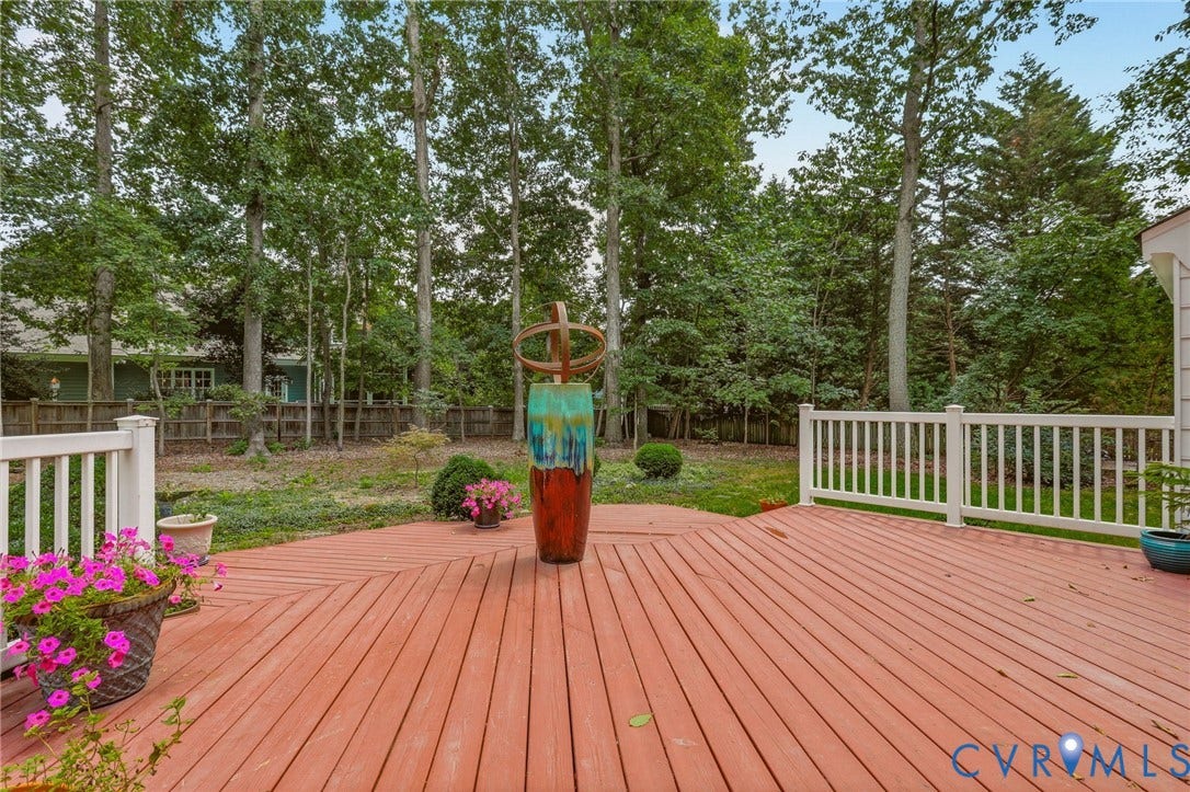 2311 Castle Hill Road, Midlothian, VA 23113 Expansive wooden deck featuring horizontal planking, white railing, and mature woodland backdrop