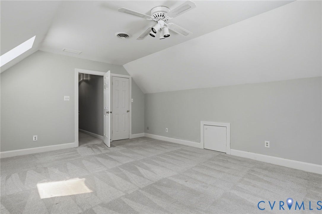 2311 Castle Hill Road, Midlothian, VA 23113 Sloped ceilings featuring a skylight, wall-to-wall carpeting, ceiling fan with attached lighting, and built-in knee-wall storage access