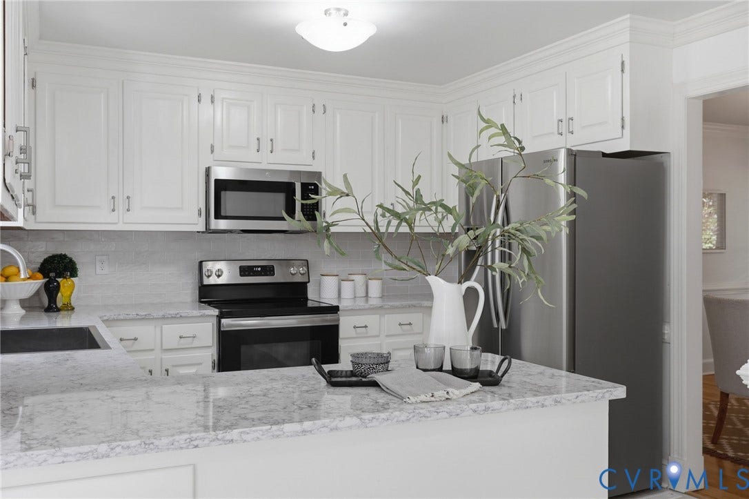 2311 Castle Hill Road, Midlothian, VA 23113 Kitchen featuring white cabinetry, stone-finish countertops, stainless steel appliances, and a central peninsula