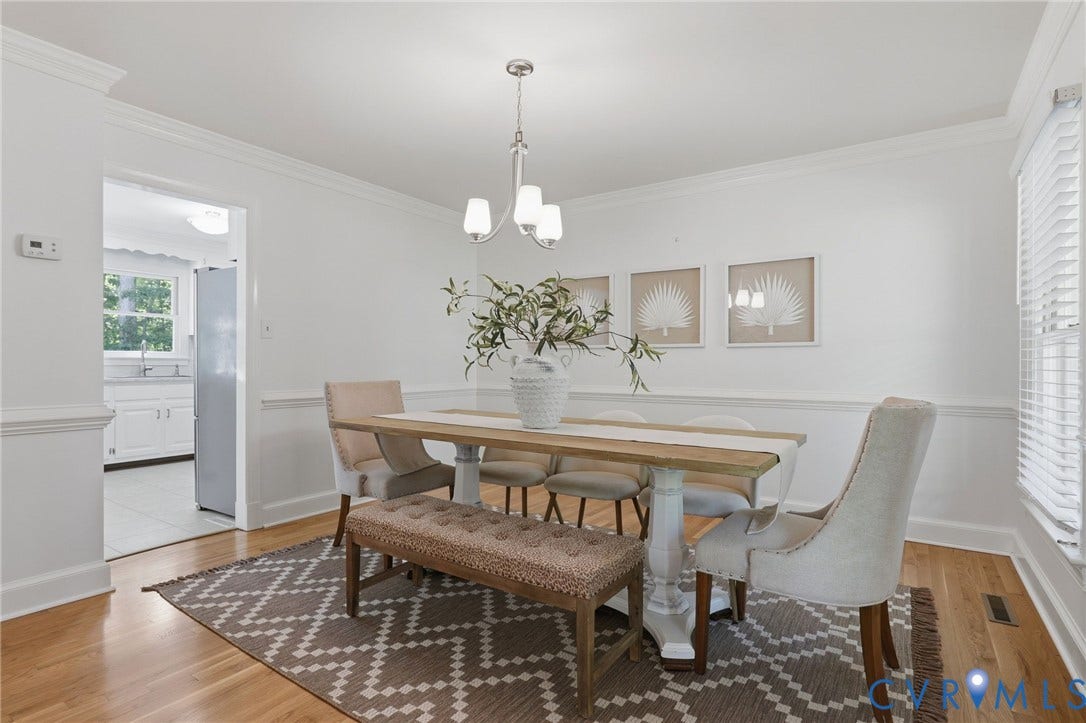 2311 Castle Hill Road, Midlothian, VA 23113 Dining area featuring wood-finish flooring, white chair rail molding, crown molding, and a three-light metal chandelier