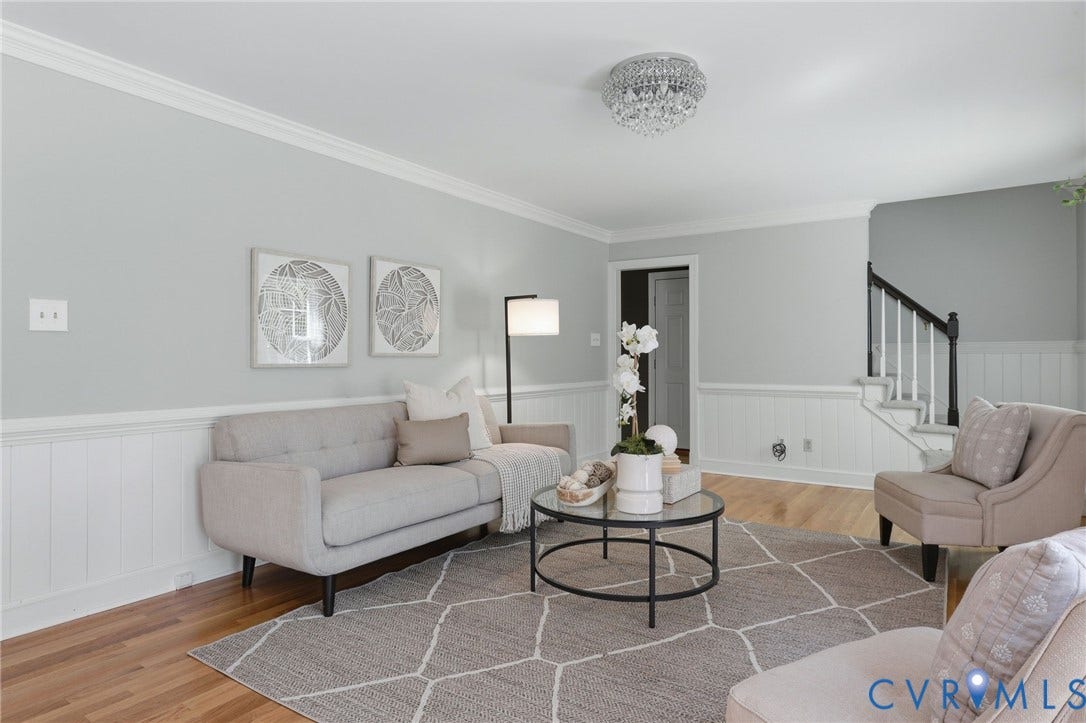 2311 Castle Hill Road, Midlothian, VA 23113 Living area featuring wood-finish flooring, white beadboard wainscoting, crown molding, a flush-mount crystal light fixture, and a staircase with a dark-stained handrail