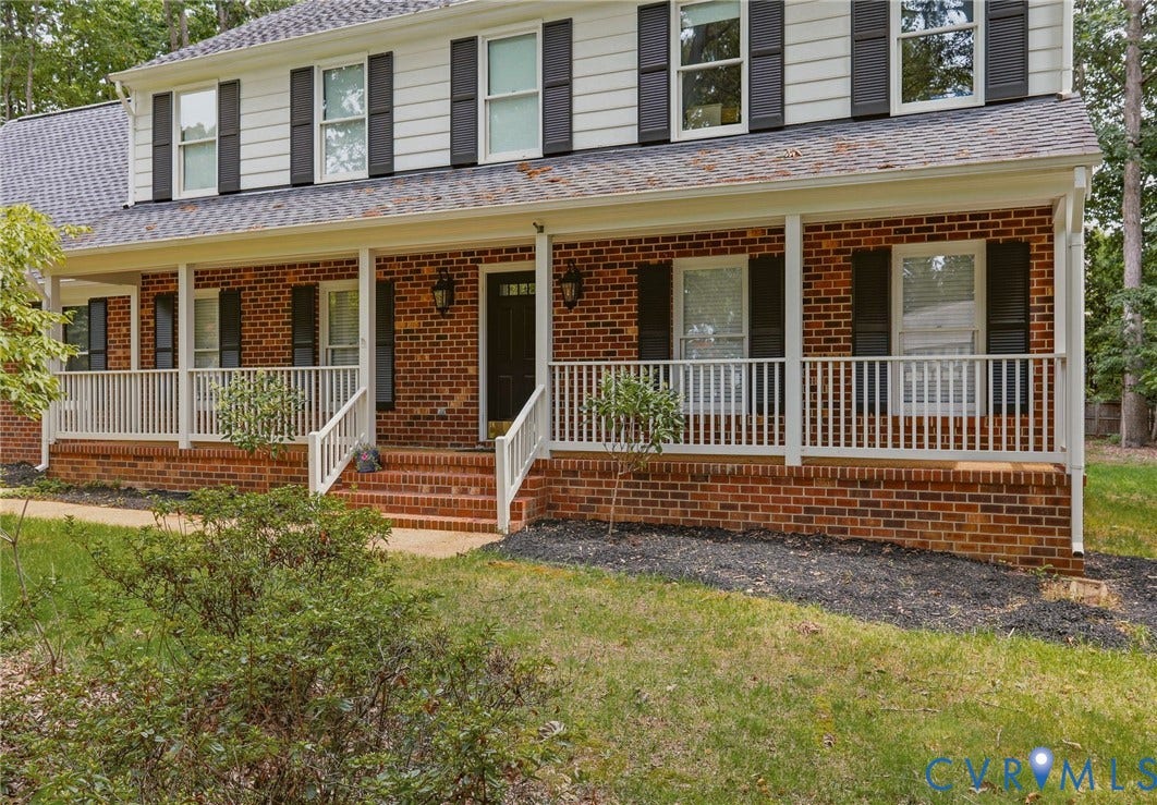 2311 Castle Hill Road, Midlothian, VA 23113 Two-story exterior featuring a brick facade, white horizontal siding, dark decorative shutters, a shingled roof, and a covered front porch with white railing