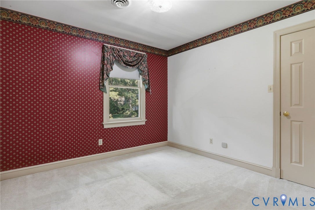 2311 Castle Hill Road, Midlothian, VA 23113 Neutral carpeting, patterned wallpaper, and a single-hung window with a decorative valance