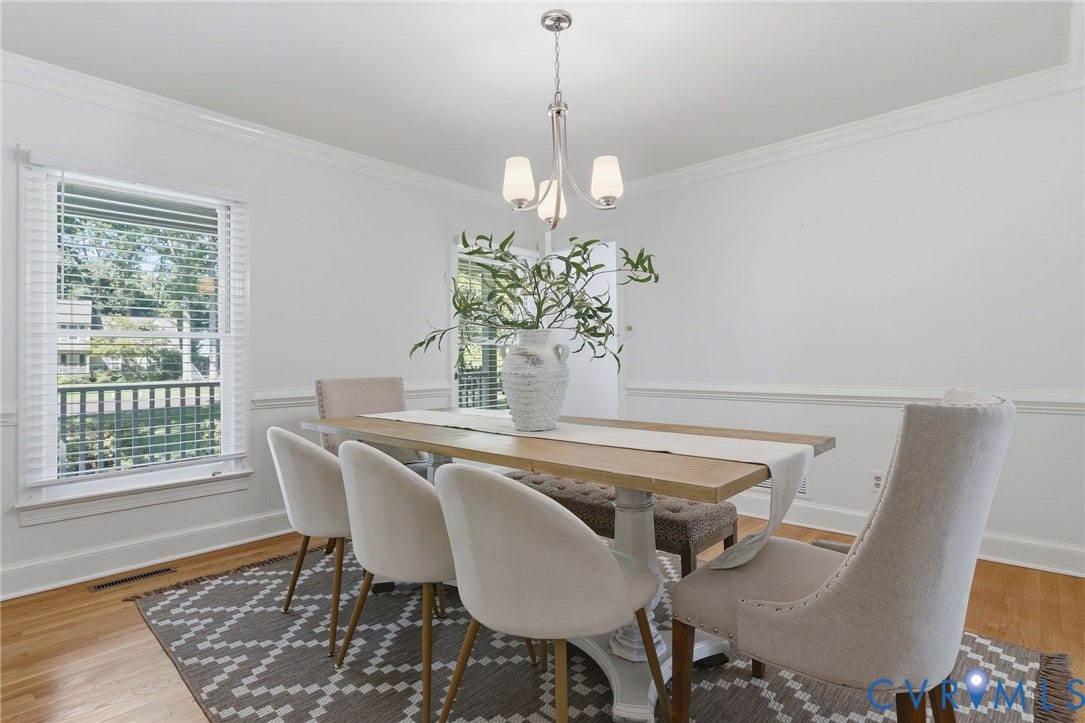 2311 Castle Hill Road, Midlothian, VA 23113 Dining area featuring hardwood flooring, crown molding, chair rail trim, and a three-light brushed nickel chandelier