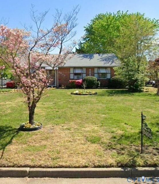 3405 Jowin Lane, Henrico, VA 23223 Single-story brick exterior featuring light-colored shutters, asphalt shingle roofing, and established landscaping with flowering ornamental trees
