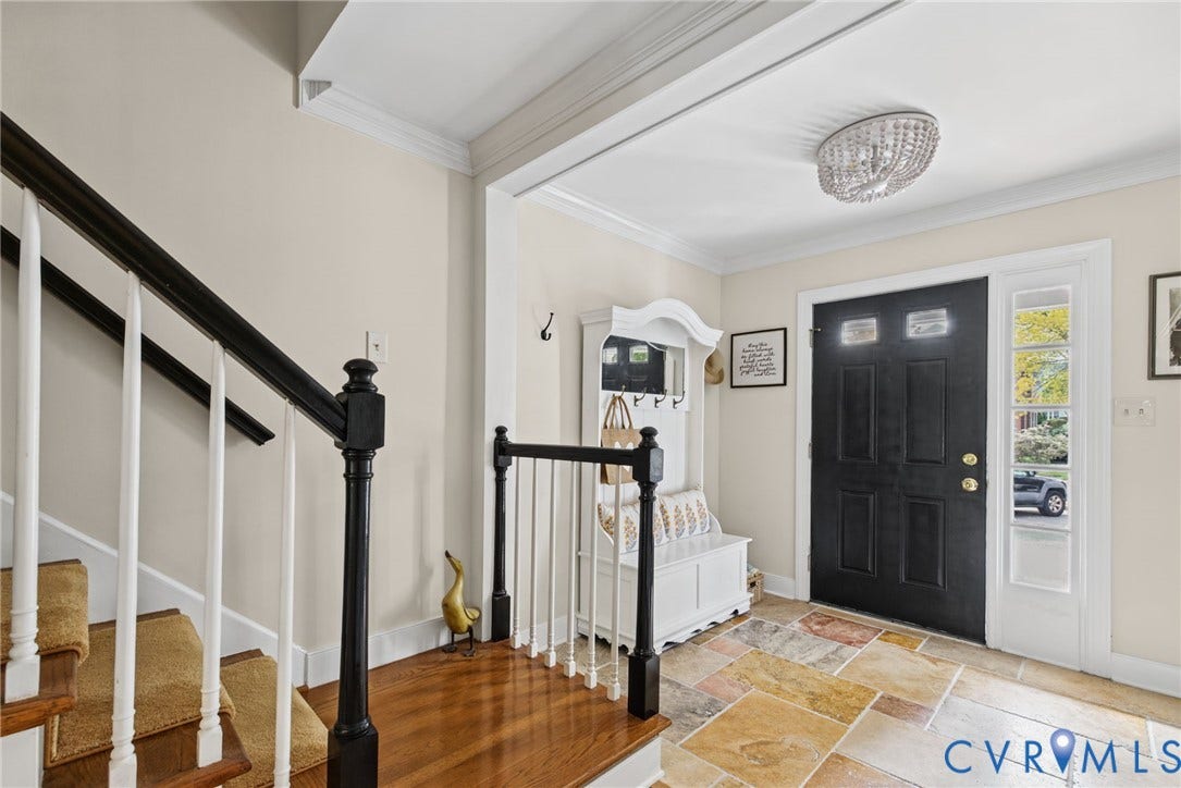 13908 Pagehurst Terrace, Salisbury, Midlothian, VA 23113 Foyer featuring natural stone flooring, a dark-finished wooden staircase with white balusters, crown molding, and a beaded semi-flush mount light fixture