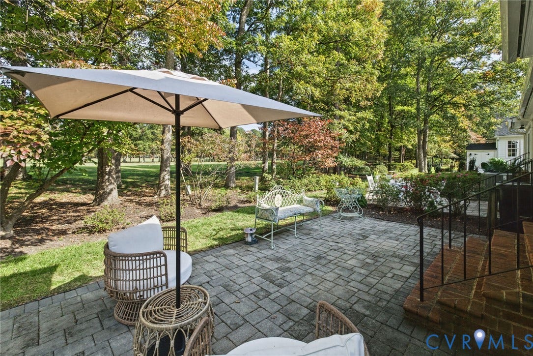 13908 Pagehurst Terrace, Salisbury, Midlothian, VA 23113 Paver stone patio featuring brick steps, metal railing, and mature landscaping