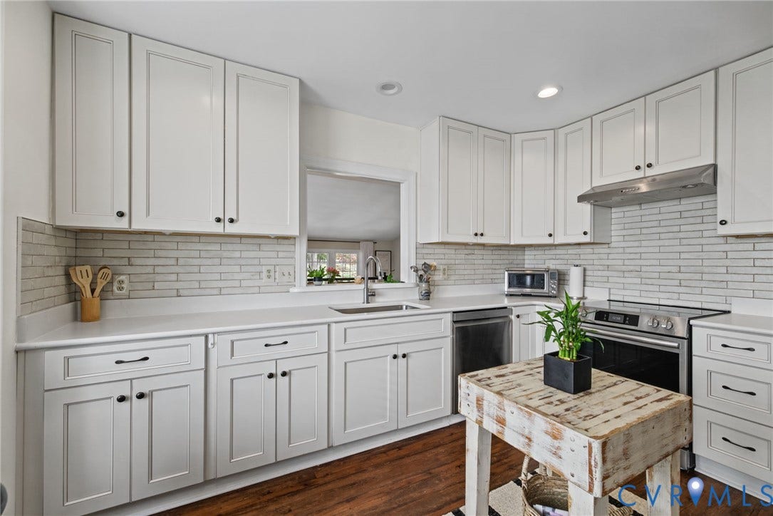 13908 Pagehurst Terrace, Salisbury, Midlothian, VA 23113 Kitchen featuring white cabinetry, solid surface countertops, subway tile backsplash, stainless steel appliances, and wood-finish flooring