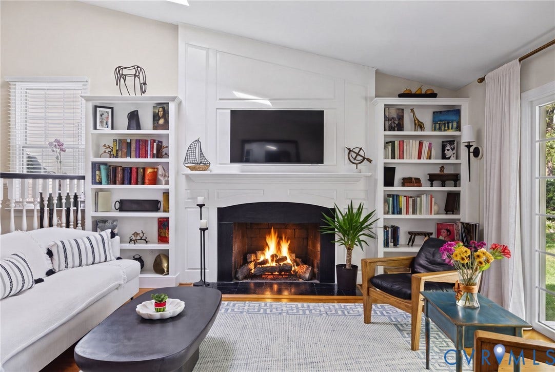 13908 Pagehurst Terrace, Salisbury, Midlothian, VA 23113 Fireplace with a black surround and mantel, flanked by floor-to-ceiling built-in cabinetry with integrated shelving