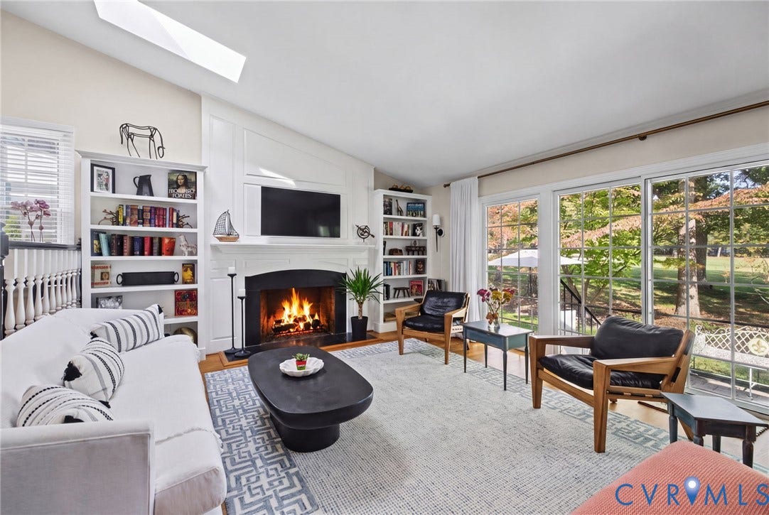 13908 Pagehurst Terrace, Salisbury, Midlothian, VA 23113 Vaulted ceiling with a skylight, fireplace featuring a classic mantel, built-in shelving, and large sliding glass doors