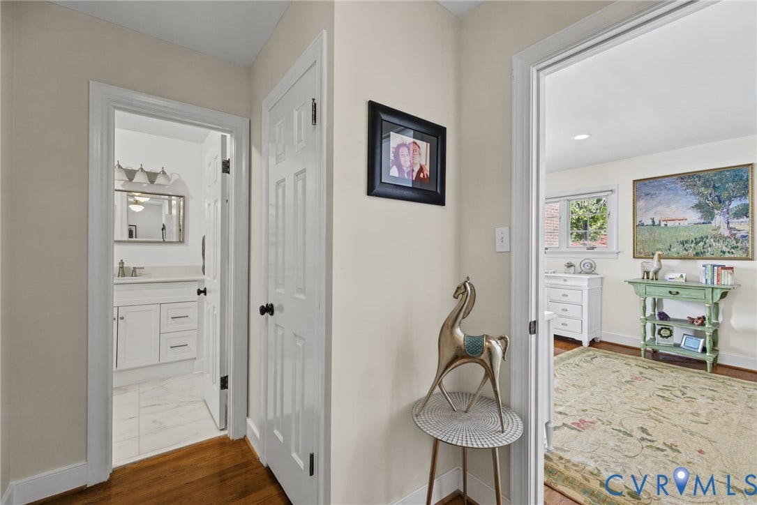 13908 Pagehurst Terrace, Salisbury, Midlothian, VA 23113 Interior hallway featuring hardwood flooring, six-panel interior doors with matte black hardware, and crisp neutral wall paint