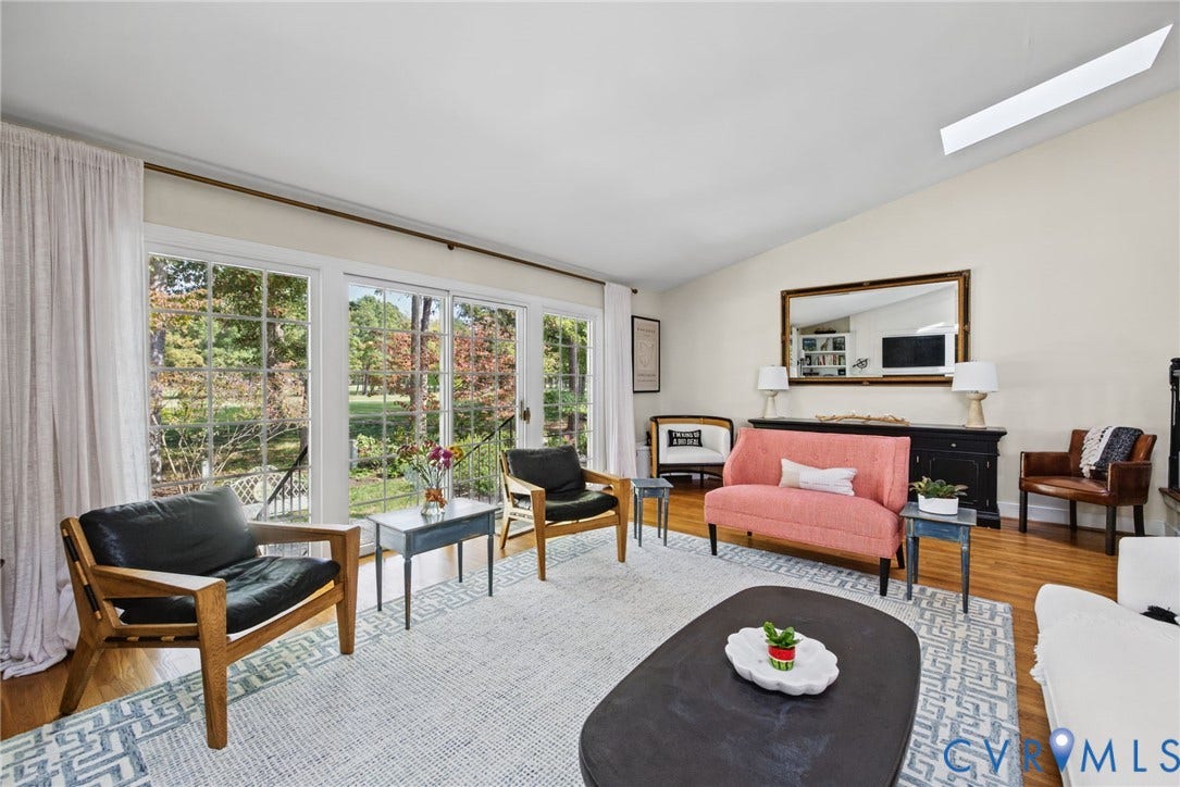13908 Pagehurst Terrace, Salisbury, Midlothian, VA 23113 Vaulted ceilings with a recessed skylight, expansive floor-to-ceiling glass sliding doors, and wood-finish flooring