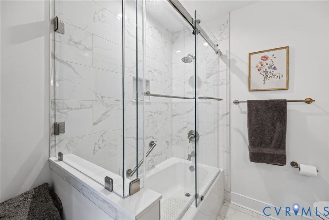 13908 Pagehurst Terrace, Salisbury, Midlothian, VA 23113 Frameless glass shower enclosure, tub with surround featuring rectified-edge tile, integrated wall niche, and metal hardware