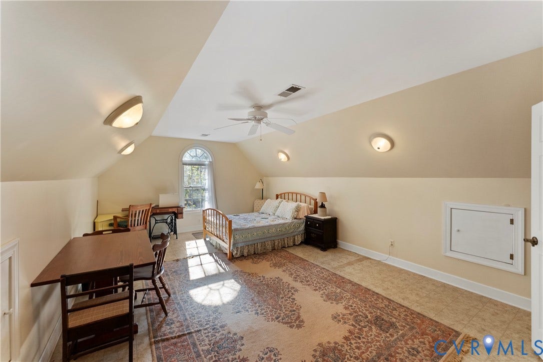 Vaulted ceilings, arched window, ceiling fan, and built-in access panel