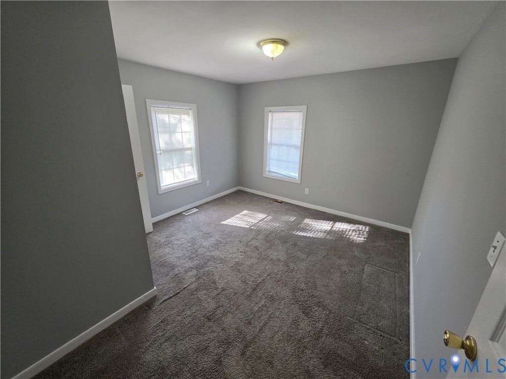 2406 Trenton Street, Hopewell, VA 23860 Neutral wall tones, wall-to-wall carpeting, two multi-pane windows, and a flush-mount ceiling fixture