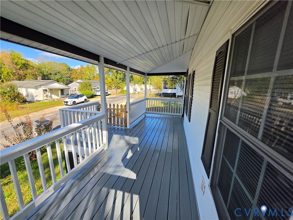 2406 Trenton Street, Hopewell, VA 23860 Covered front porch featuring painted wood decking, white baluster railings, and a gated entrance