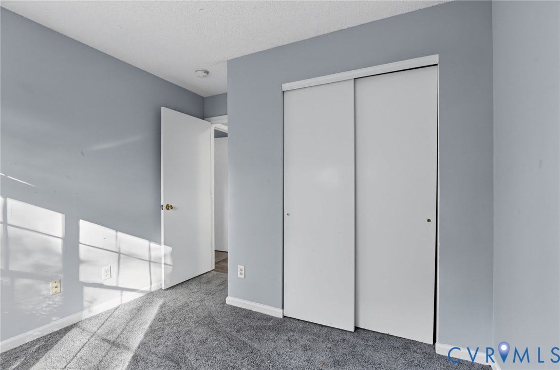 910 Rue Marseille, Les Chateaux, Chesapeake, VA 23320 Room featuring grey carpeting, neutral wall paint, and a sliding-door closet