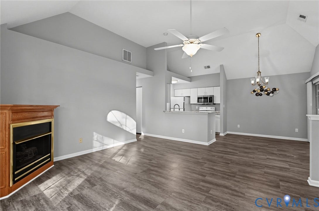 910 Rue Marseille, Les Chateaux, Chesapeake, VA 23320 Vaulted ceilings with a ceiling fan, wood-finish flooring, and a fireplace with a wood mantel